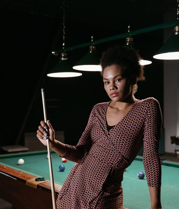 Woman holding a challenging balance pose, demonstrating focus.
